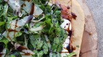 Arugula Topped Prosciutto Pizza with Basalmic Drizzle